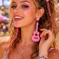Model wearing pink guitar earrings festival styling UK