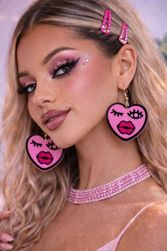 Model wearing pink heart earrings festival styling UK