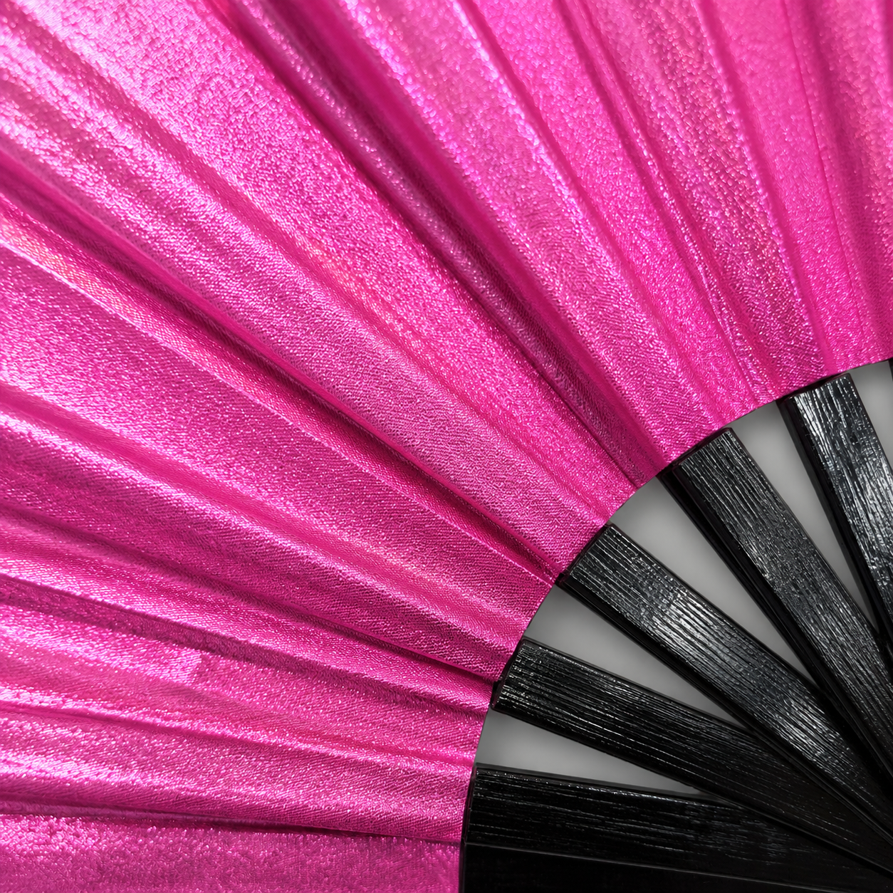 Close-up showing metallic hot pink shimmer texture on WonkiWear XL festival fan