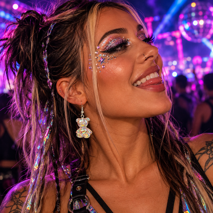 Woman wearing iridescent bear drop earrings at a neon rave festival