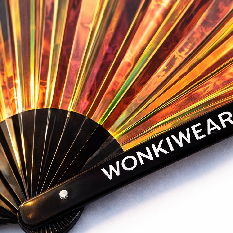 Close up of iridescent festival fan with WonkiWear logo and holographic material detail