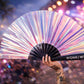 Person holding iridescent festival fan at rave with colourful lights and crowd background