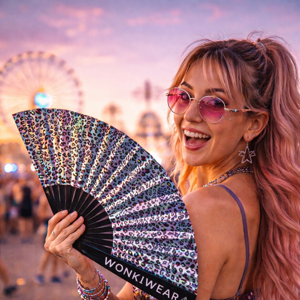 Woman holding iridescent leopard rave fan at festival with reflective silver finish WonkiWear