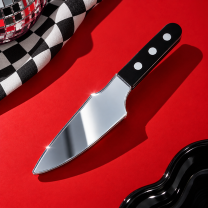 Large knife-shaped hair clip with reflective silver blade and black handle by Cuteryko