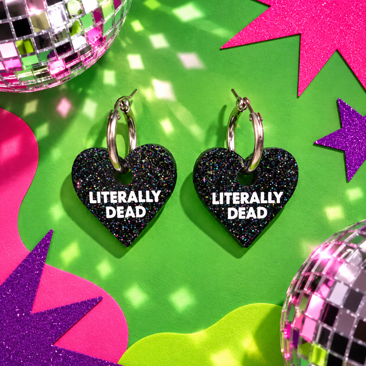 Literally Dead heart hoop earrings with black glitter heart charms and white lettering by Cuteryko
