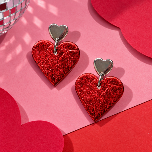 Lovestruck Leigh red metallic heart drop earrings with silver heart-shaped stud tops by Trend Tonic