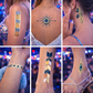 Metallic gazing eye temporary tattoos glowing under flash lighting at night festival