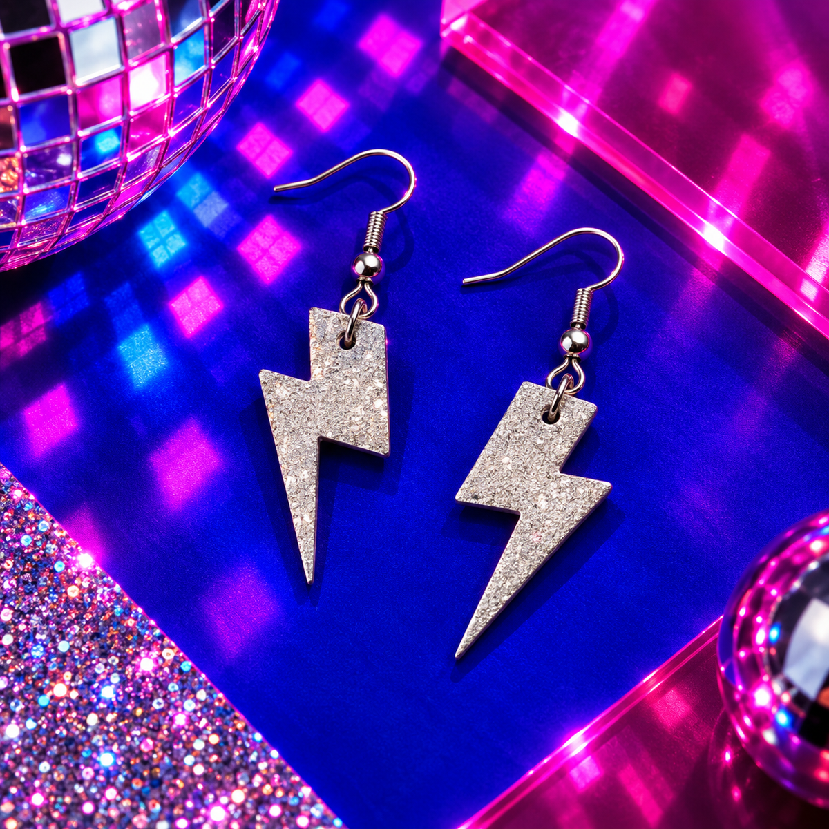 Mini silver glitter cork lightning bolt earrings with stainless steel hooks by Trend Tonic