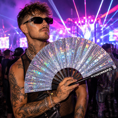 Male festivalgoer holding Mirror Maze holographic XL festival fan