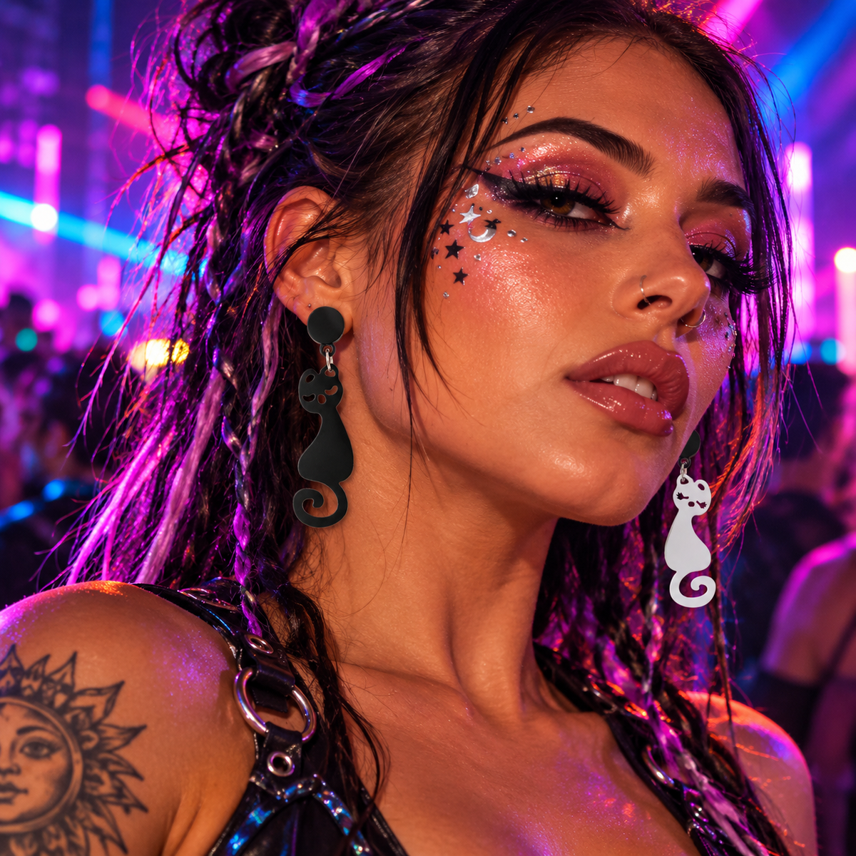 Woman wearing mismatched black and white cat earrings at a neon rave
