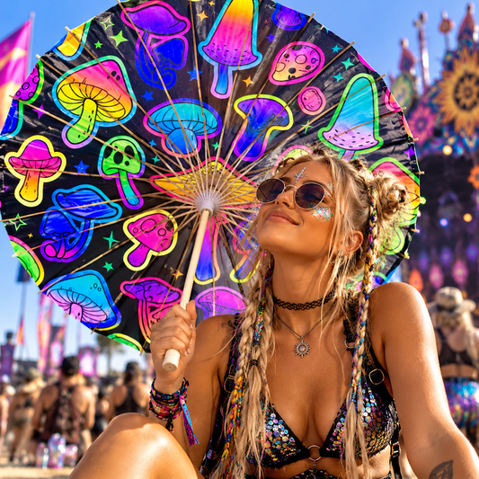 Neon mushroom print sun parasol held by a festivalgoer at a colourful outdoor music festival.