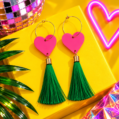 Neon pink heart earrings with long emerald green tassels and gold hoops