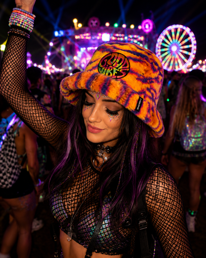 Neon tiger stripe furry bucket hat styled at a festival rave setting