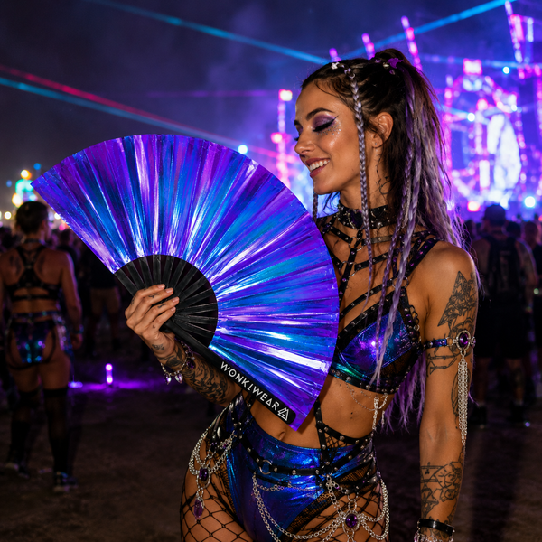 Festival attendee using Neptune Galaxy iridescent fan at music festival