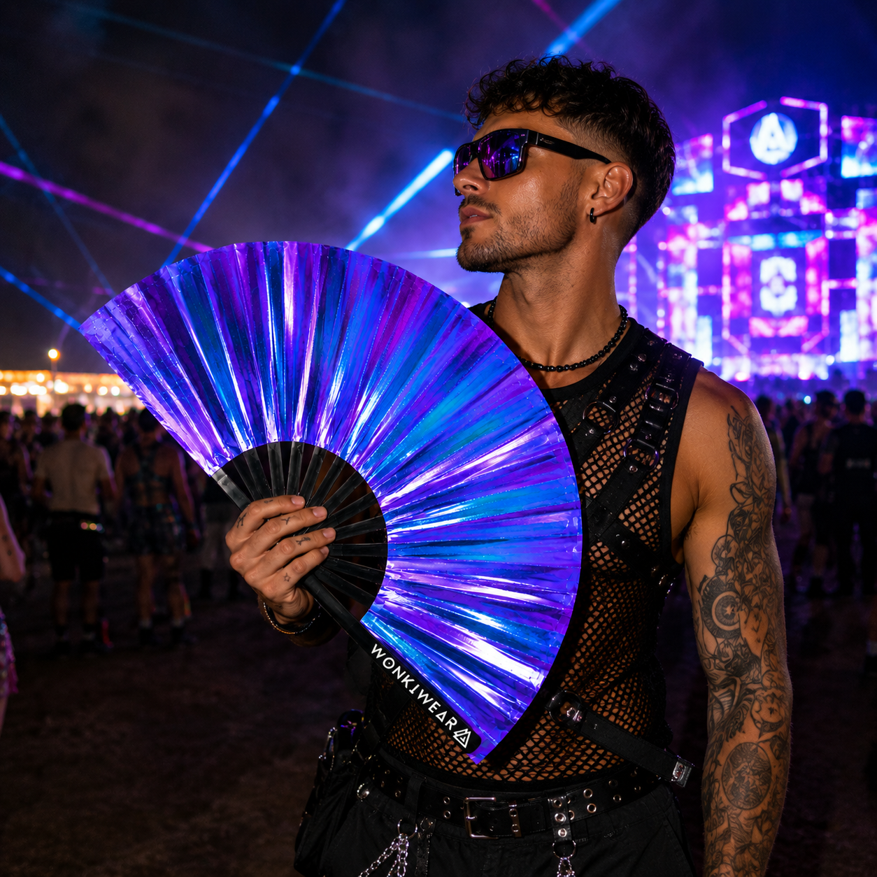 Male festival goer holding Neptune Galaxy iridescent XL festival fan