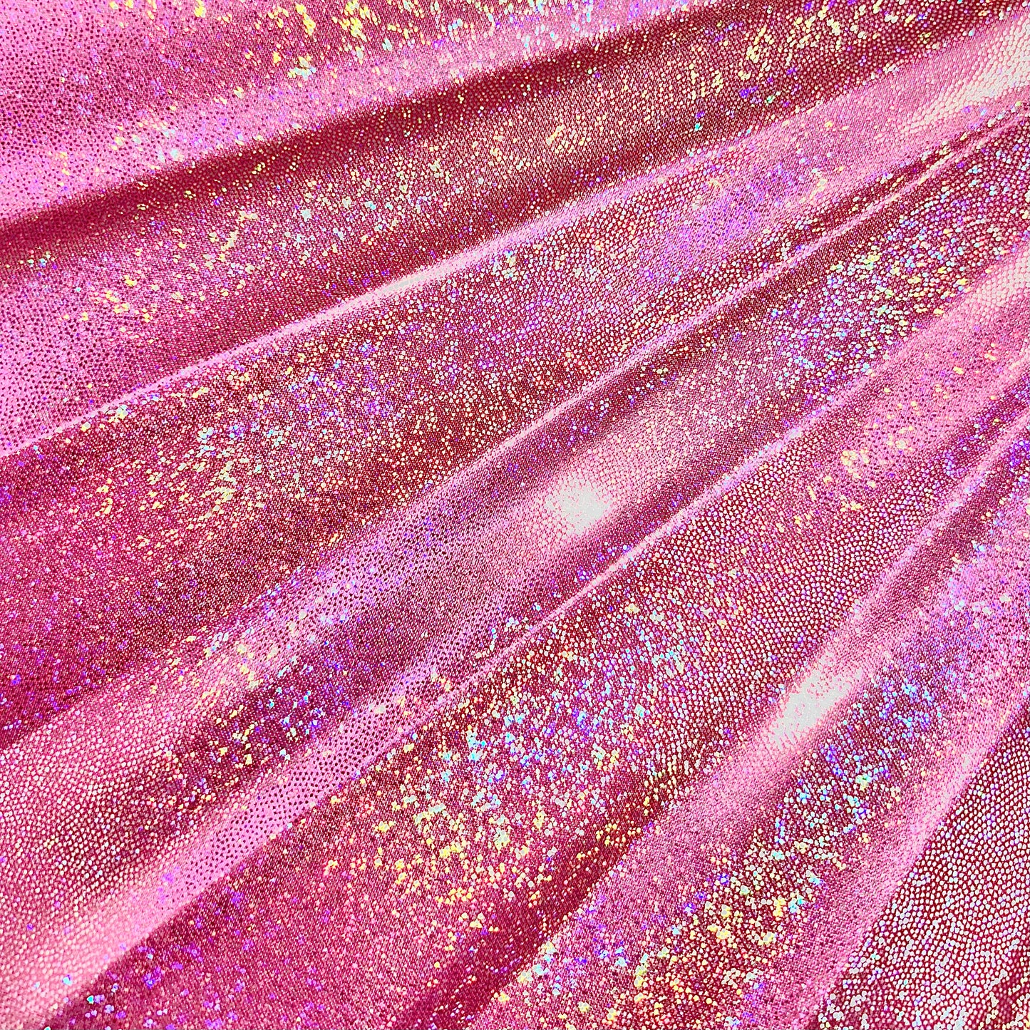 Close-up of Orion Galaxy holographic metallic pink fabric showing rainbow reflective sparkle detail
