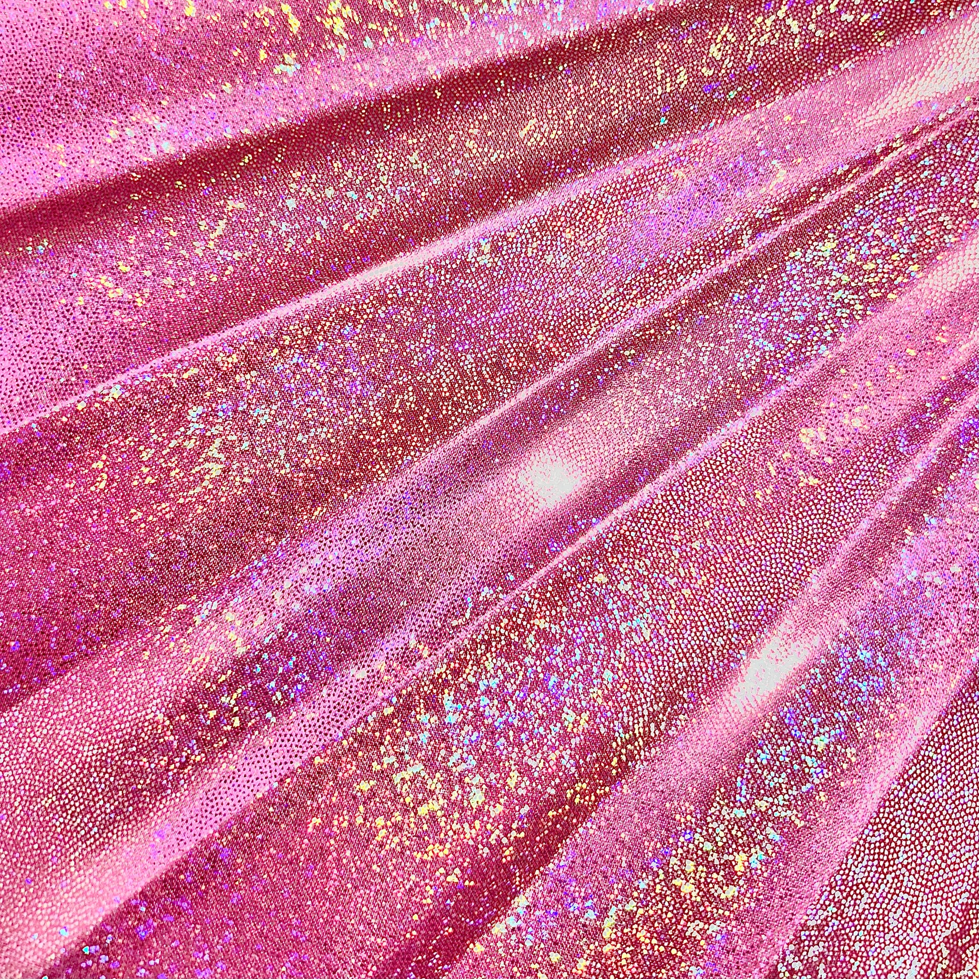 Close-up of Orion Galaxy holographic metallic pink fabric showing rainbow reflective sparkle detail