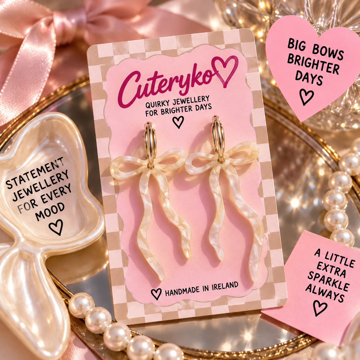 Pearlescent beige dangly bow hoop earrings with long ribbon tails by Cuteryko
