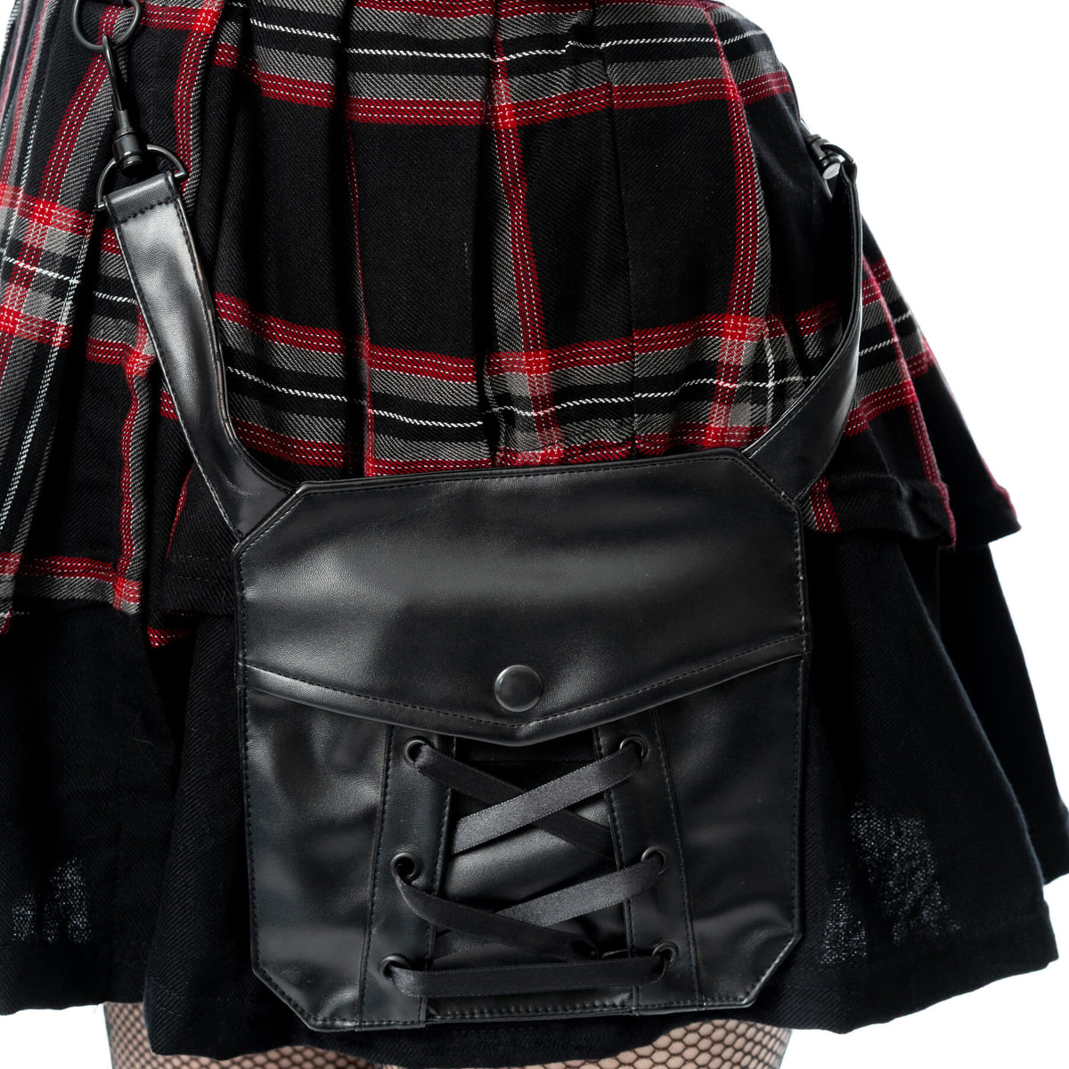 Detail of the Phantom Highlander skirt by Poizen Industries, highlighting the black PVC belt and tartan panel design.