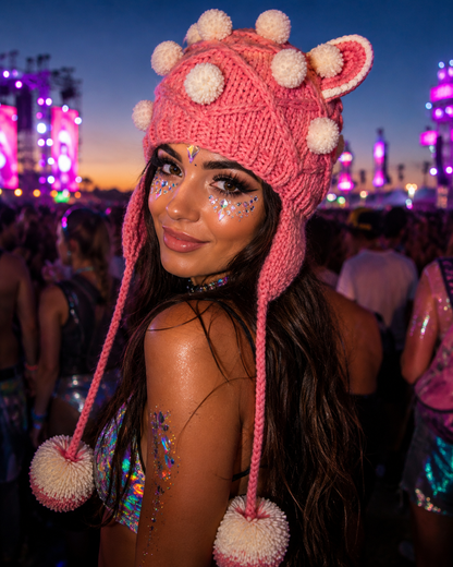 Woman wearing pink cat ear knitted festival hat at an outdoor music festival