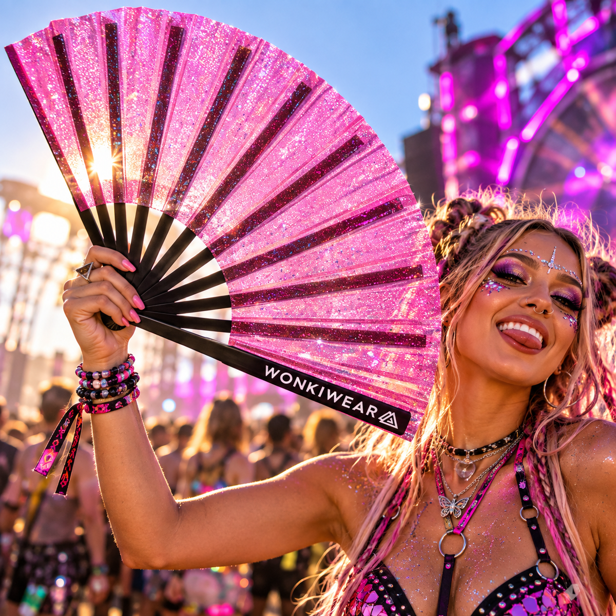 XL semi-transparent pink glitter festival fan with black ribs held by a woman at a colourful rav