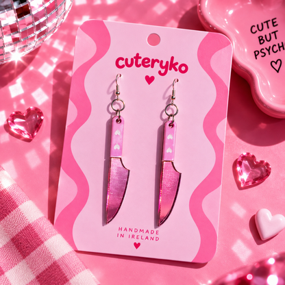 Pink knife earrings with glittery acrylic detail and heart accents by Cuteryko