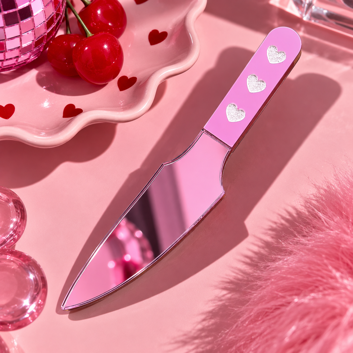 Pink large knife-shaped hair clip with silver heart details and reflective blade by Cuteryko