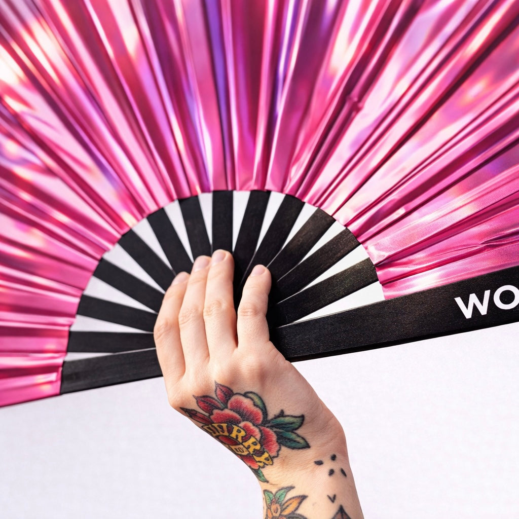 Close up of Pink Mirage iridescent rave fan showing metallic pink reflective material and structure