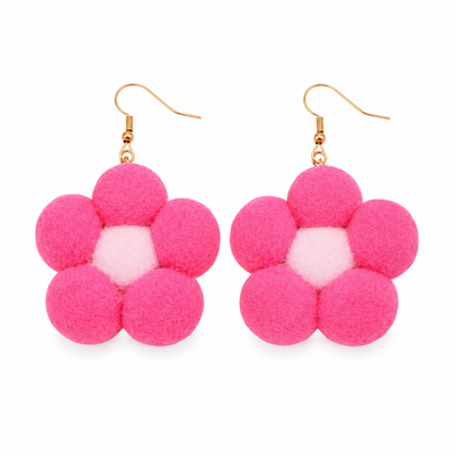 Pink handmade pom pom daisy flower statement earrings on white background