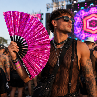 Male festival goer holding Pink Pulse holographic XL festival fan