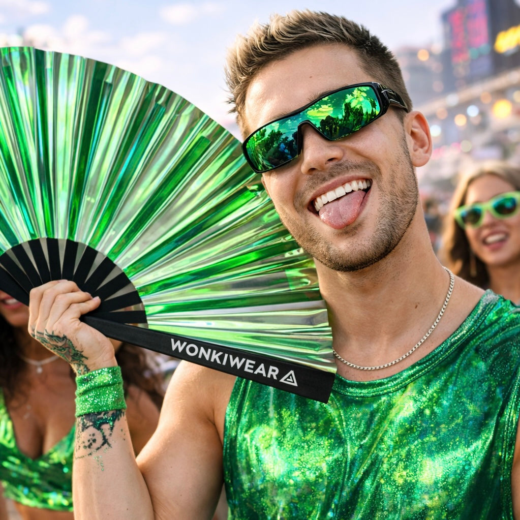 Man holding Pixie Dust green holographic rave fan at festival with reflective metallic finish