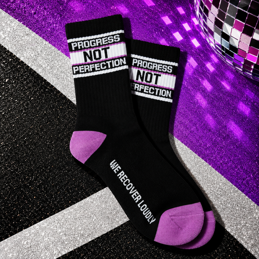 Black Progress Not Perfection recovery socks with lavender heel and toe