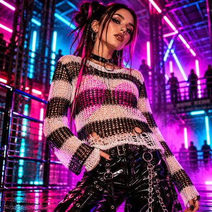 Punk Rave Cosima white and black striped open-knit sweater styled over a hot pink top with glossy PVC trousers at a neon rave