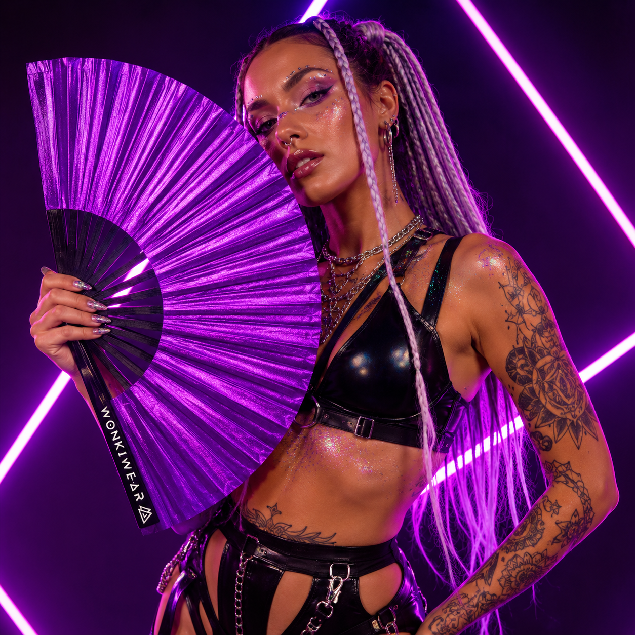 Festival model holding XL purple shimmer metallic festival fan during neon studio photoshoot