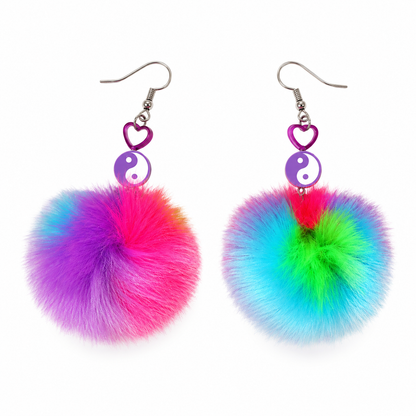 Multicoloured fluffy pom pom yin yang statement earrings on white background