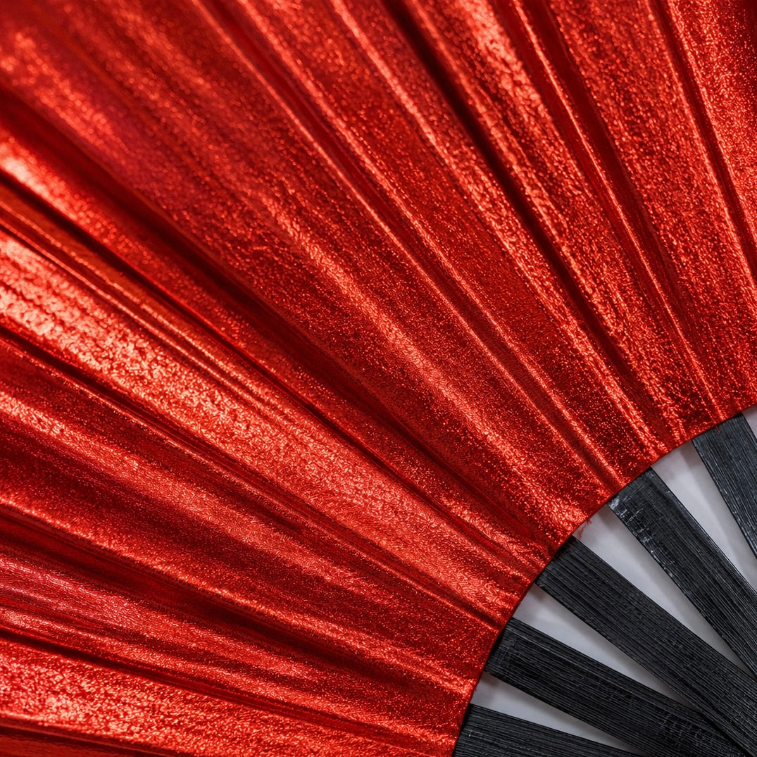 Close-up showing metallic red shimmer texture on WonkiWear XL festival fan