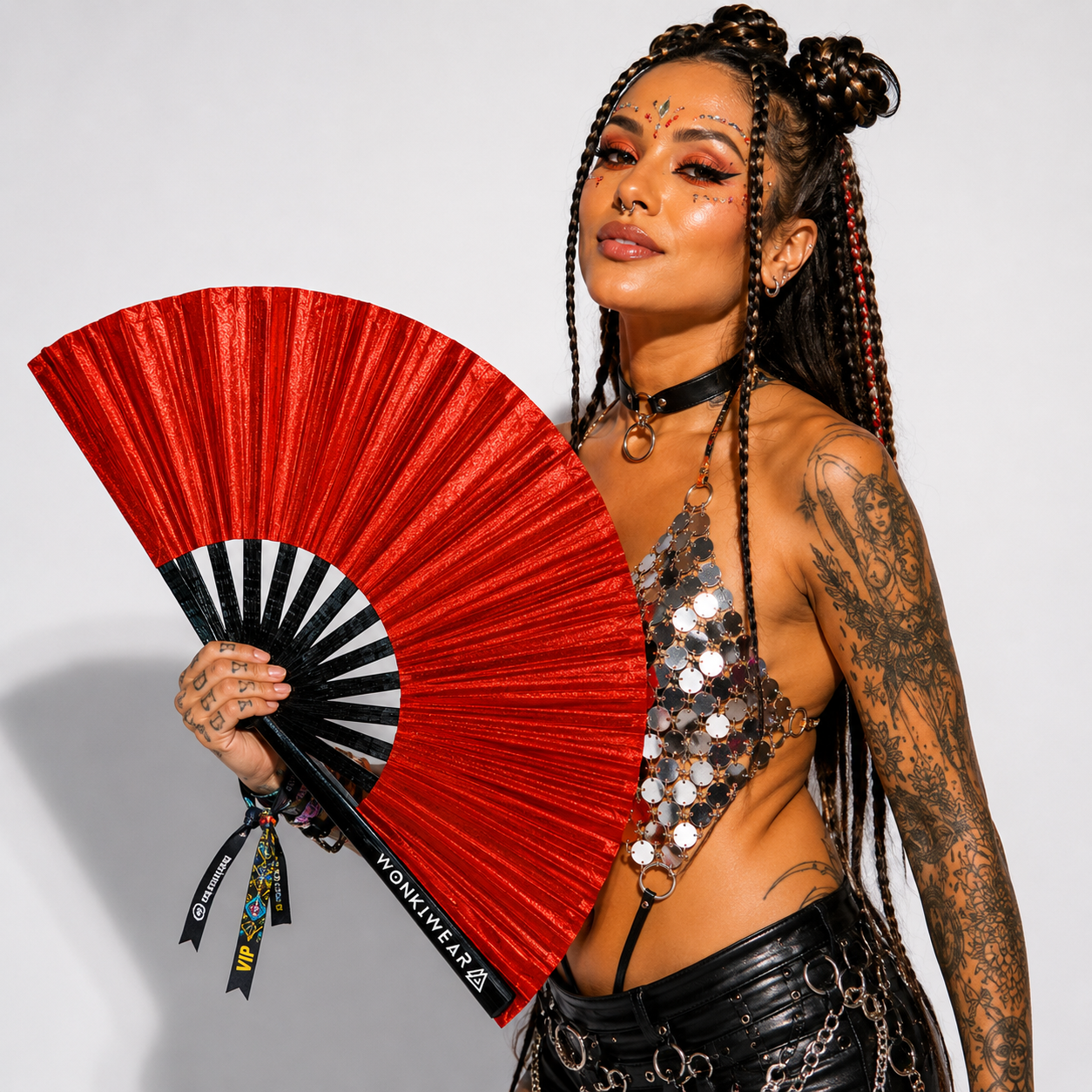 Festival model holding XL red shimmer metallic festival fan during studio photoshoot