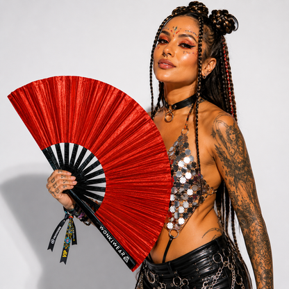 Festival model holding XL red shimmer metallic festival fan during studio photoshoot