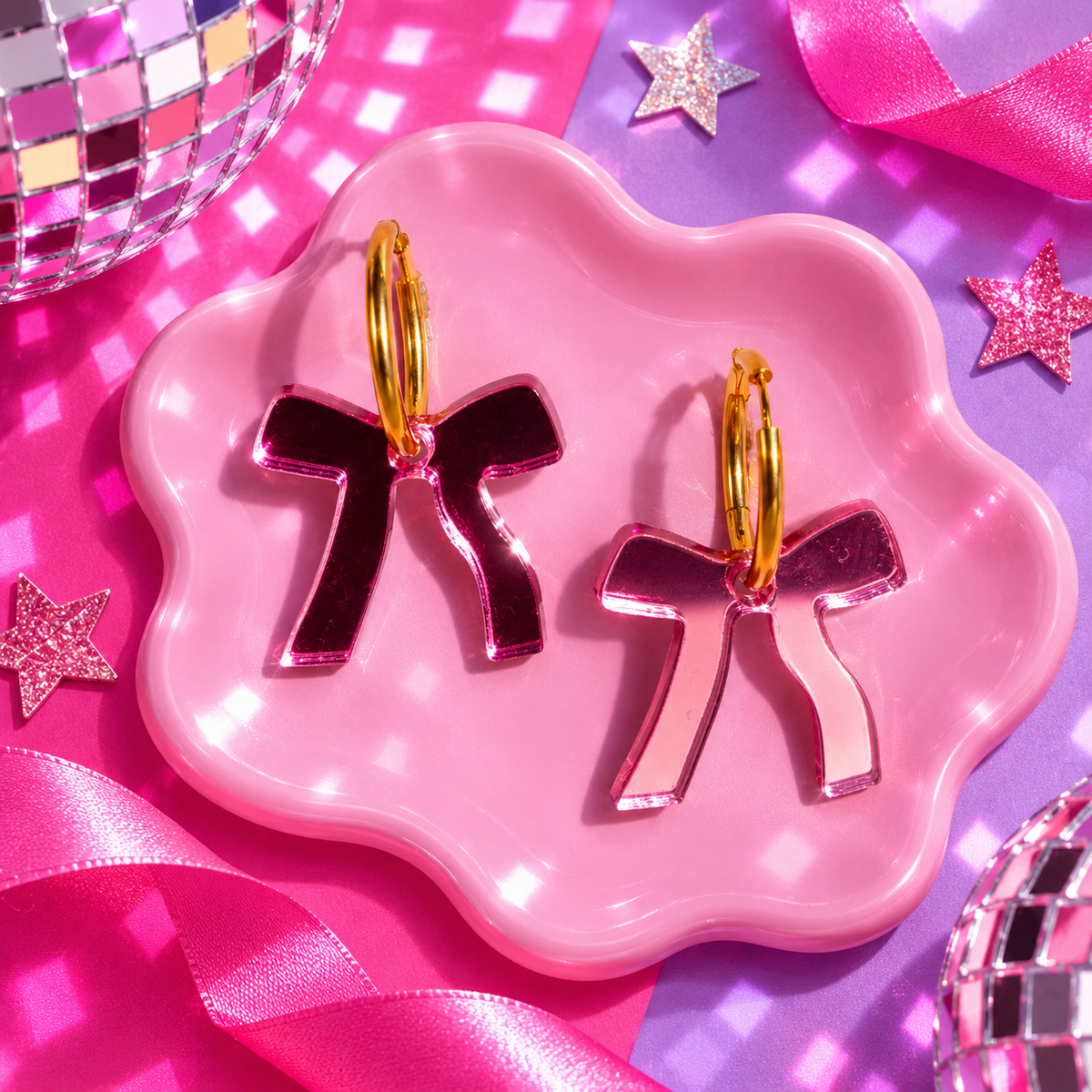 Reflective Pink Bow Hoop Earrings with metallic pink bow charms and gold hoops by Cuteryko
