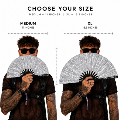 Size comparison of medium and XL silver glitter festival fans held by model