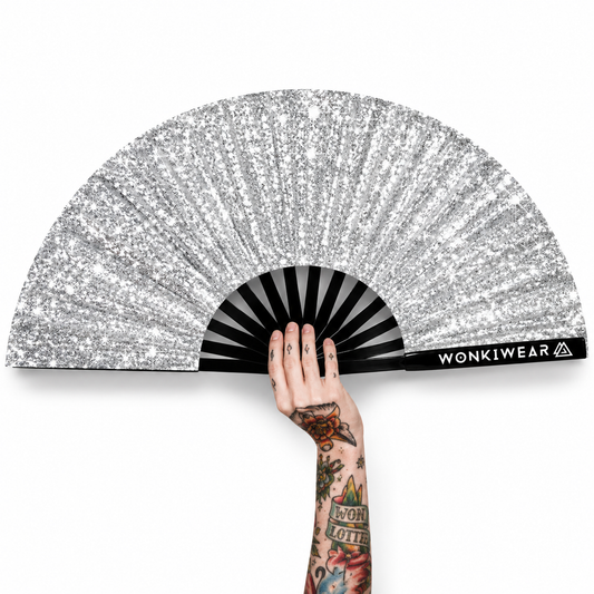 Silver glitter folding festival fan with tattooed hand on white background