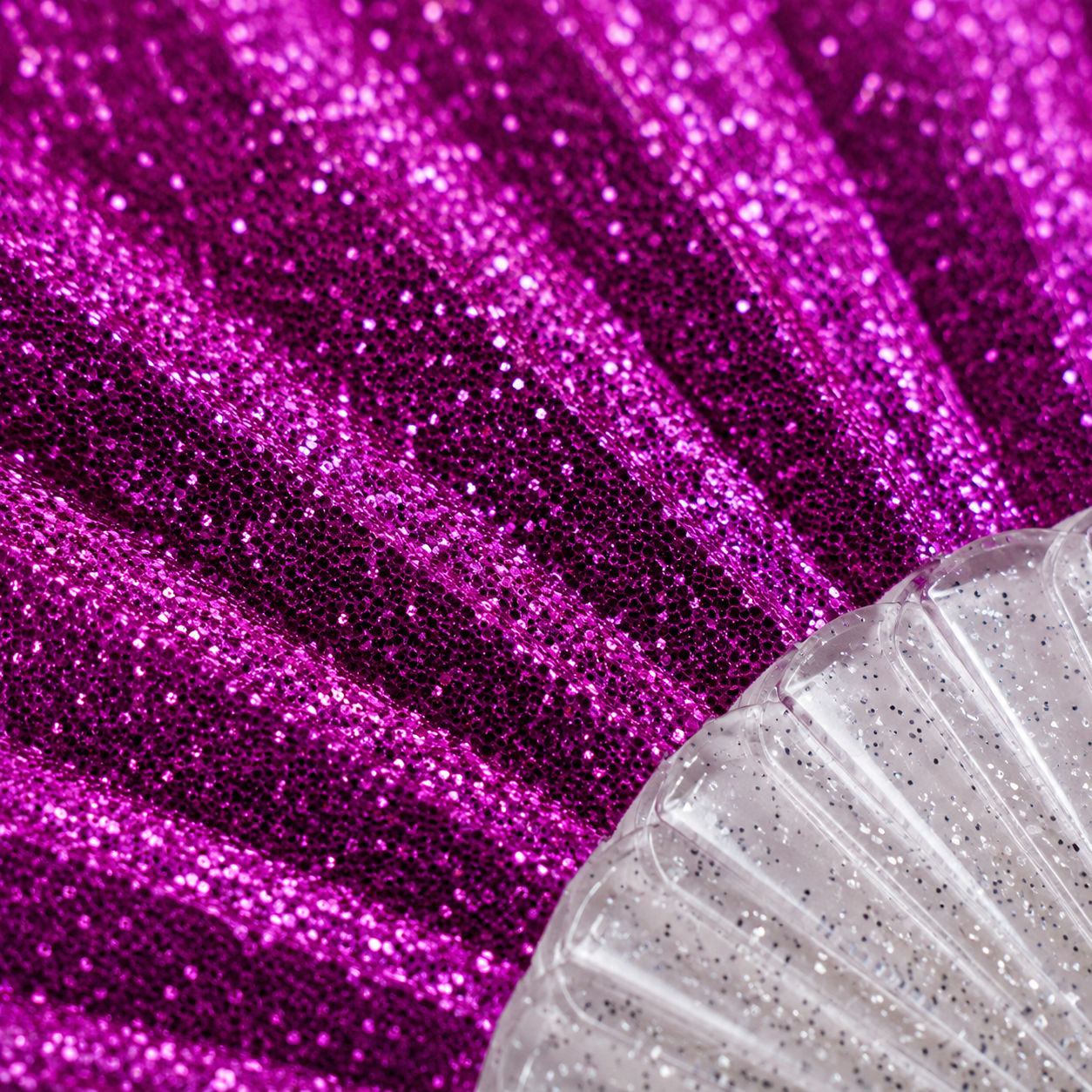 Macro close-up showing sparkling bright pink glitter fabric detail