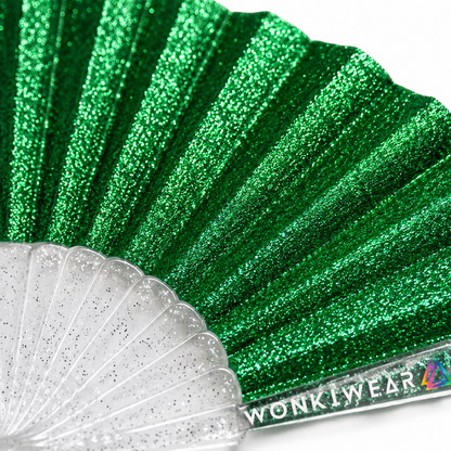 Macro close-up of emerald green glitter fabric showing sparkling texture and shimmer detail