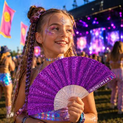 Child holding small purple glitter folding fan at colourful festival event