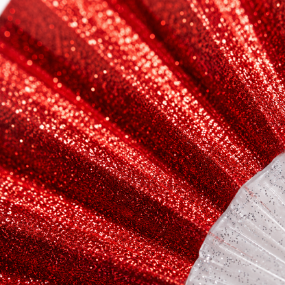 Macro close-up of red glitter fabric showing sparkling texture detail
