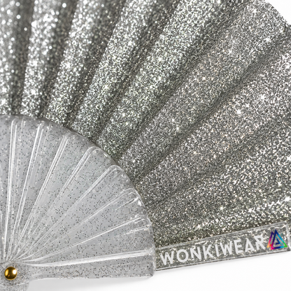 Macro close-up of silver glitter fabric showing sparkling shimmer texture and reflective detail