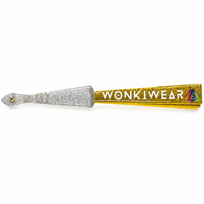 Close-up of folded yellow gold glitter fan showing transparent plastic handle with silver glitter speckles