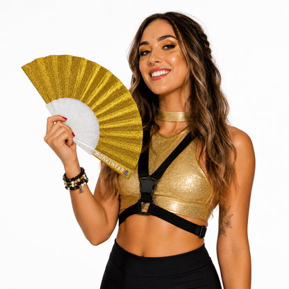 Festival model holding yellow gold glitter folding fan during studio photoshoot