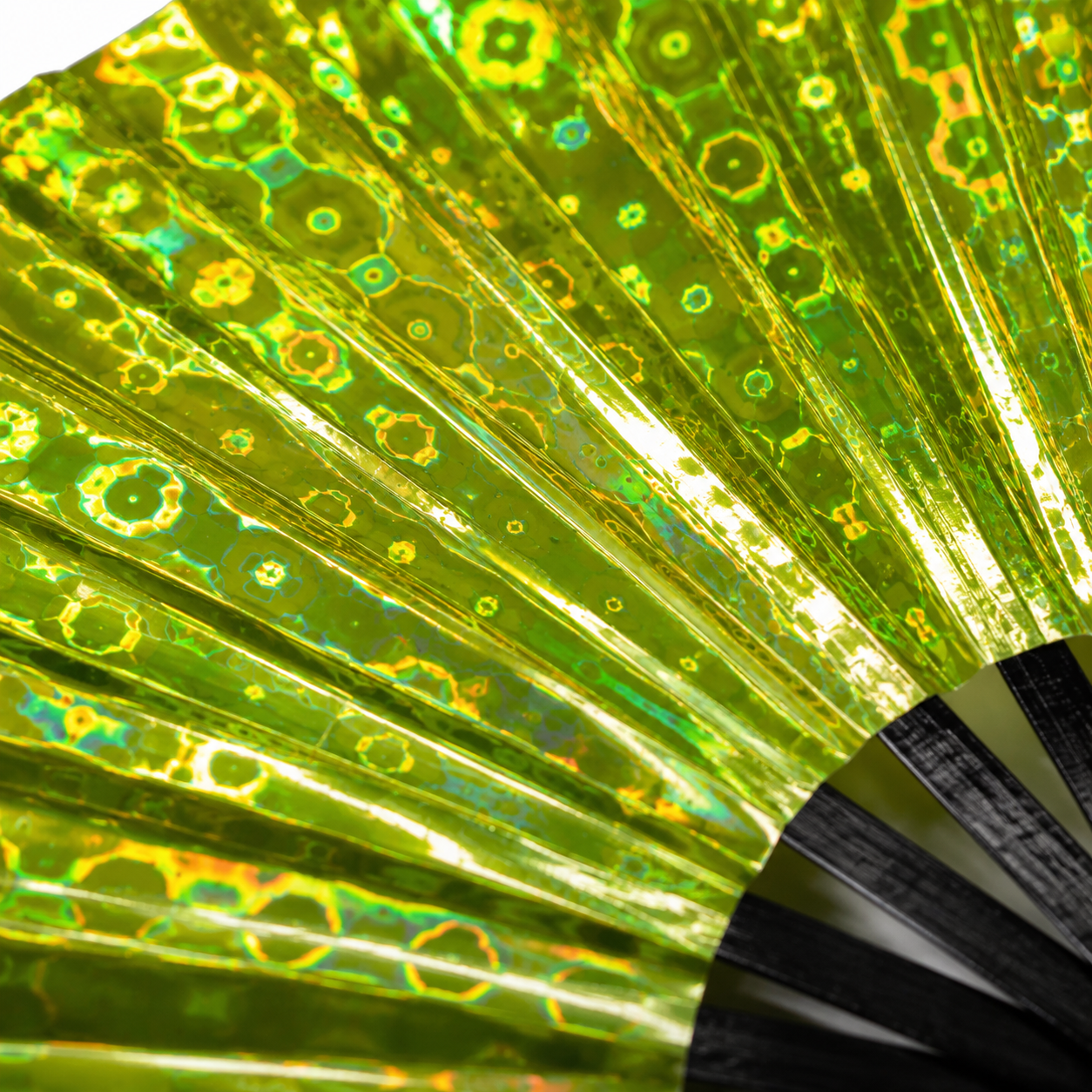 Close-up of Solar Flare holographic festival fan showing yellow and lime iridescent detail
