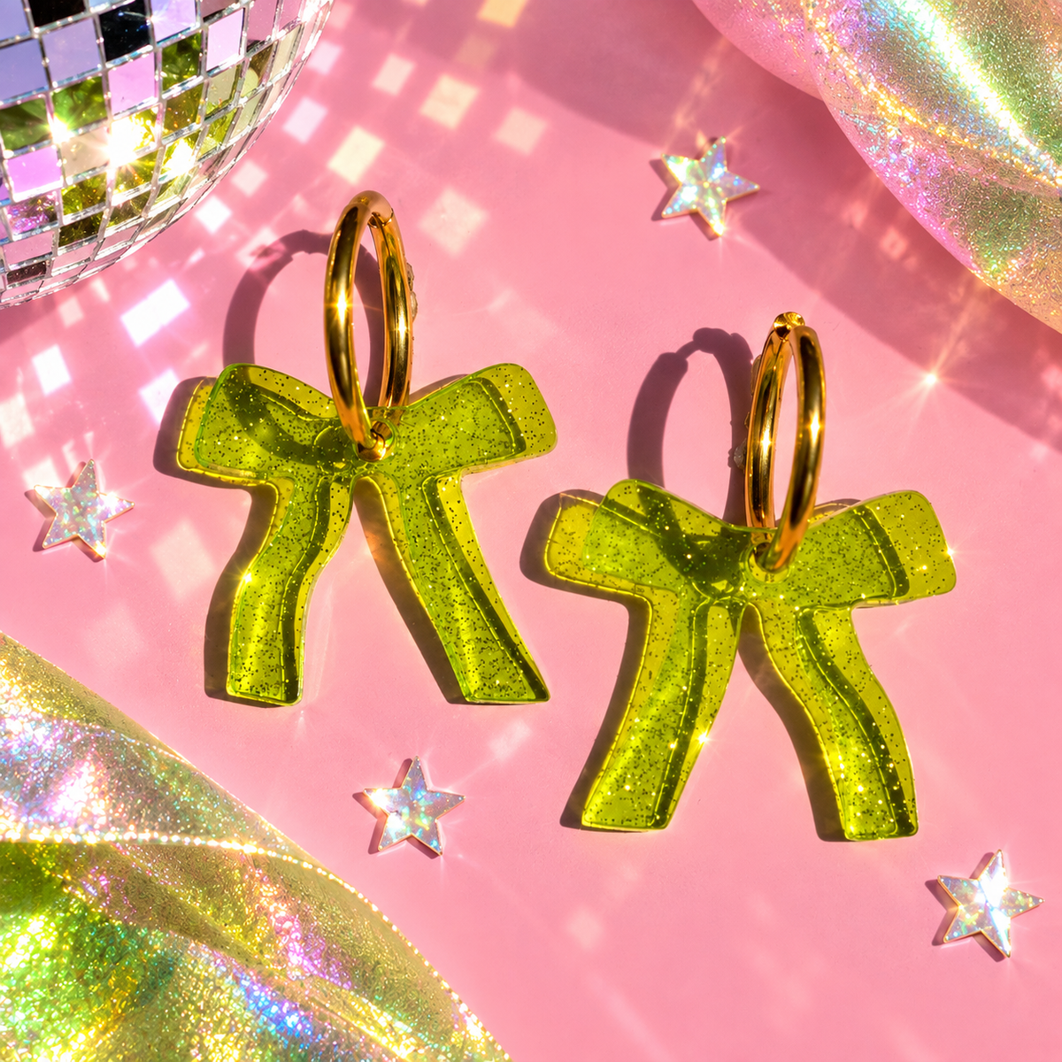 Sparkly green bow hoop earrings with translucent glitter bow charms by Cuteryko